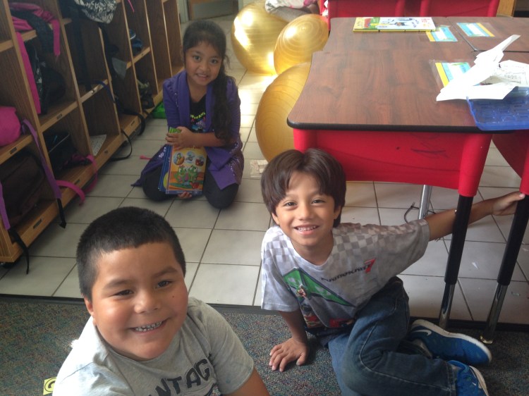 kids at a charity outreach smiling at camera